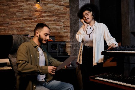 A man and woman in a recording studio, engrossed musical notes and singing.