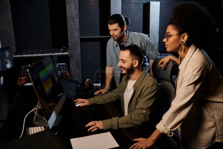 A diverse group of musicians studying a computer screen in a recording studio, focused and engaged in the creative process.