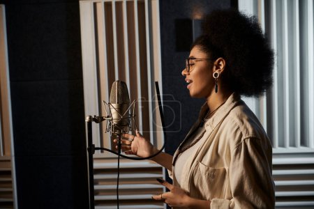 A talented woman passionately sings into a microphone in a bustling recording studio during a music band rehearsal.