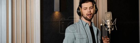 Photo for A man passionately performs vocals into a studio microphone during a music band rehearsal session. - Royalty Free Image