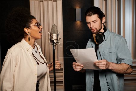 A man and a woman collaborate in a recording studio, creating music for their band rehearsal.