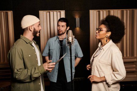 Three individuals engaged in lively discussions during a music band rehearsal in a recording studio.