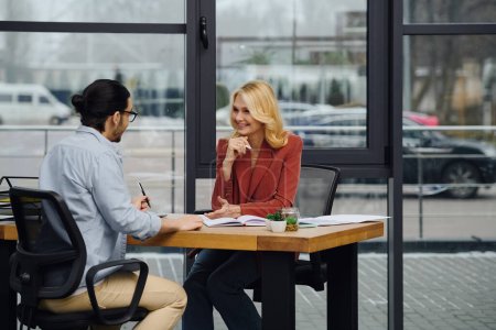 Man and woman discussing business in an office setting.
