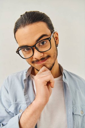 Téléchargez les photos : Un homme élégant avec des lunettes frappe une pose. - en image libre de droit