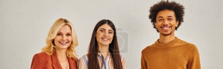 Photo for A group of people of various ethnicities and gender striking poses in front of a white backdrop. - Royalty Free Image