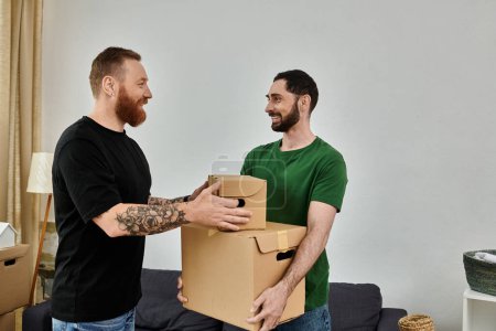 A gay couple in love stands in their living room, holding a cardboard box, ready to start their new life together.
