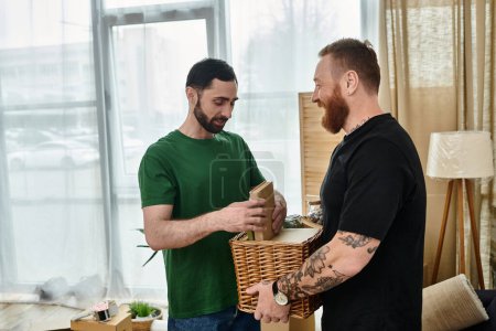 Two men, a gay couple in love, stand next to each other in their new living room surrounded by moving boxes.