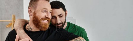 A bearded man warmly embraces his partner