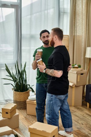 A gay couple happily standing in their new living room surrounded by moving boxes, starting a new chapter in their lives.