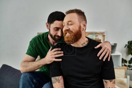 Foto de A bearded man lovingly hugs his partner in their new home, a symbol of a fresh start. - Imagen libre de derechos