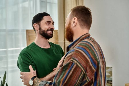 A gay couple excitedly stands in living room, starting anew in their new home.