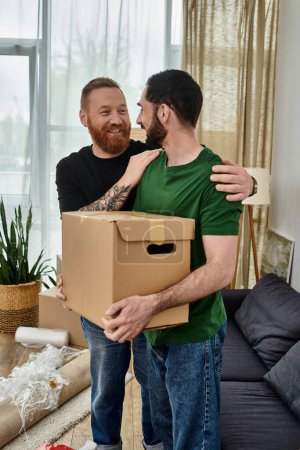 Two men, a gay couple in love, share a quiet moment in their new living room amidst moving boxes.