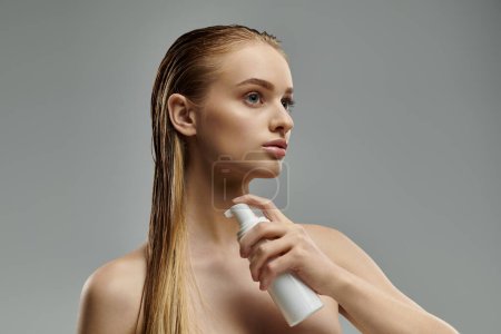 Attractive woman applying hair treatment.