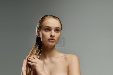 Beautiful woman with long hair tenderly applying hair care products.