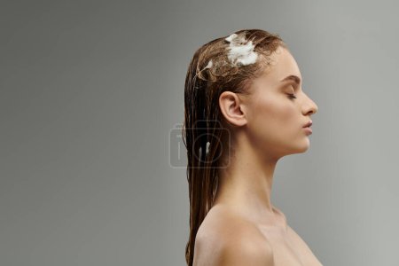 Attractive woman applying hair care product and washing hair.