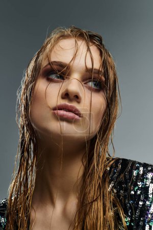 Young woman showcasing wet hair and black top.
