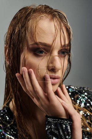 Photo for Youthful woman showcasing wet hair in a stylish pose. - Royalty Free Image