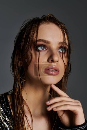 A graceful woman showcases with wet hair.