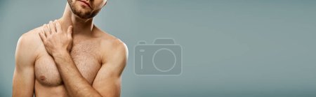 Foto de Un hombre sin camisa, barbudo, de pie con confianza, con las manos sobre el pecho en un estudio. - Imagen libre de derechos