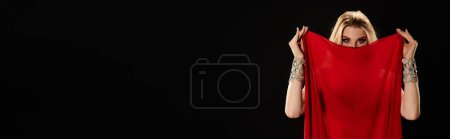 Photo for Woman in red dress hides her face. - Royalty Free Image