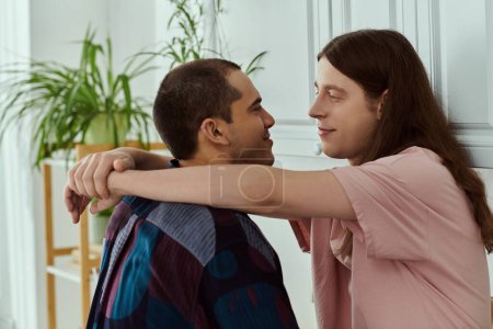 Téléchargez les photos : Un couple gay, embrasser amoureusement dans une chambre accueillante, rayonnant de bonheur et d'intimité. - en image libre de droit