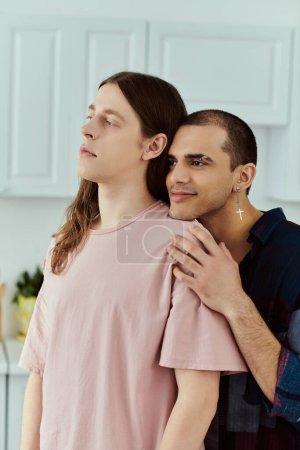 A gay couple in casual clothes sharing a tender moment in a cozy kitchen setting.