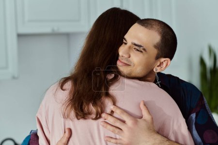 A man tenderly hugs a partner in a cozy kitchen, showing love and affection in a beautiful moment.