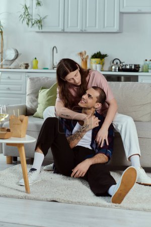 Photo for A gay couple dressed casually, enjoying a cozy moment together seated on a comfortable couch. - Royalty Free Image