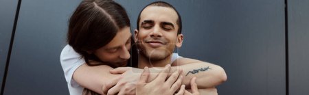 Photo for A gay couple, embrace in a loving hug outdoors, showing unity and affection. - Royalty Free Image