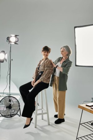 Couple lesbien d'âge moyen dans un studio photo, derrière le processus de caméra