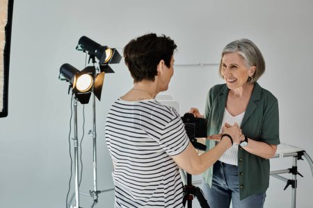 couple stand together, ready for a photo shoot in a modern studio setting.