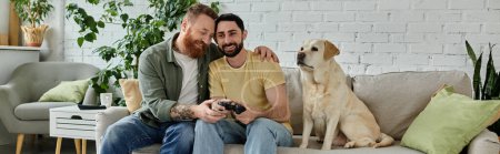 Bearded gay couple engrossed in video game with their loyal labrador on the couch.
