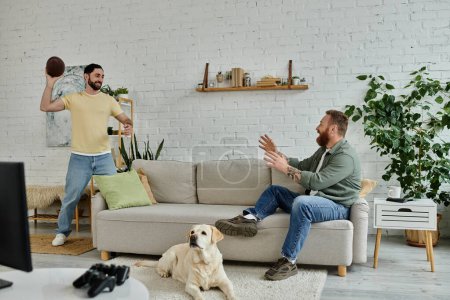 Bearded man and dog watch sports on couch in cozy living room.