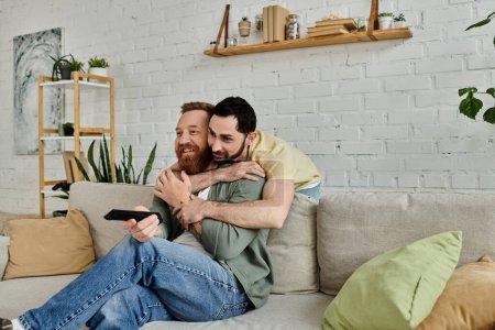 Two men with beards enjoying a cozy moment together on a couch in a living room.