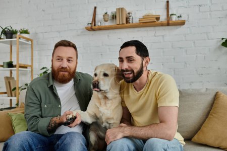 Bearded gay couple enjoying quality time with their furry friend, a labrador, lounging on a cozy couch at home.