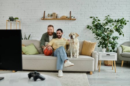 Two bearded men relax on a couch with their furry labrador in a cozy living room setting.