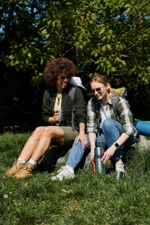 Two young women, take a break from hiking to enjoy the outdoors.