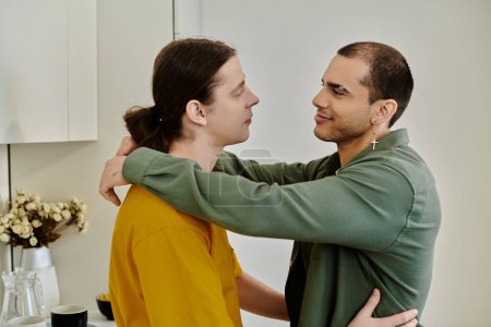 A young gay couple embraces in a modern apartment, showcasing their affection and connection.