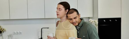 Two young men share a moment of intimacy in their modern apartment kitchen.
