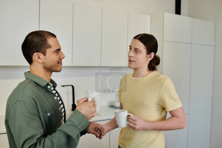 A young gay couple enjoys a cozy morning in their modern apartment, sharing coffee and conversation.