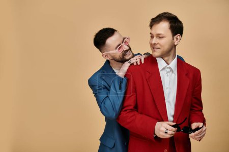 A gay couple in dapper suits share a playful moment, their laughter and affection palpable.