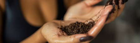 Cropped view of african american woman holding natural coffee scrub in shower cabin, banner 
