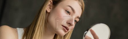 Photo for Pretty young woman looking at blurred mirror at home, banner - Royalty Free Image