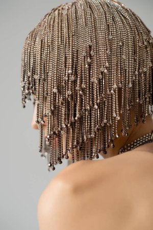 Jewelry headwear on young model with naked shoulder isolated on grey  