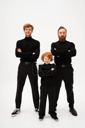 Photo for Full length of bearded man with redhead son and smiling grandson posing with crossed arms on light grey background - Royalty Free Image
