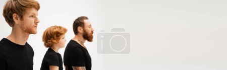 Photo for Side view of bearded men and red haired kid in black t-shirts isolated on grey, banner - Royalty Free Image