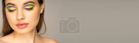 Téléchargez les photos : Teen girl with colorful eyeshadows posing isolated on grey, banner - en image libre de droit