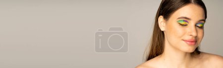 Teen model with multicolored visage and freckles posing isolated on grey, banner 
