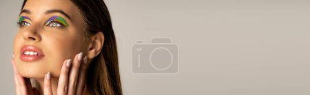 Téléchargez les photos : Pretty teen girl with creative visage touching face isolated on grey, banner - en image libre de droit