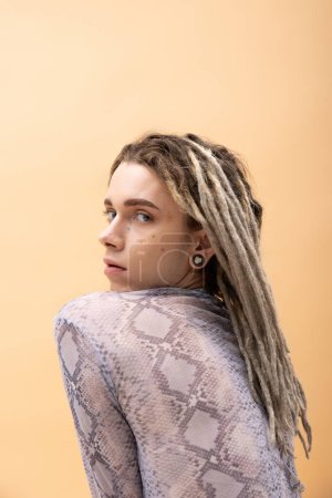 Photo for Queer person with dreadlocks looking at camera isolated on yellow - Royalty Free Image